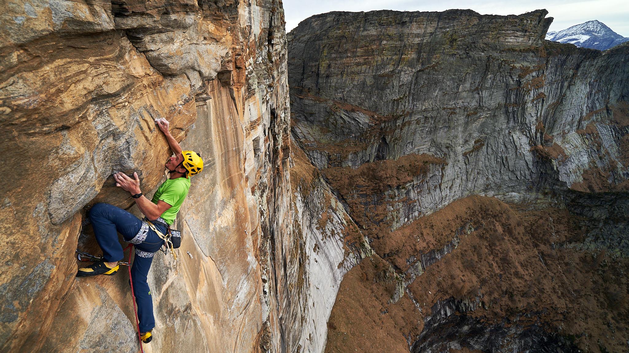 Man scaling a mountain face