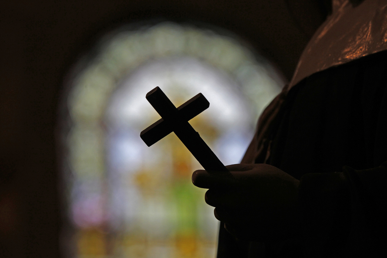 priest holding a crucifix